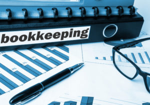 bookkeeping files and papers on a desk